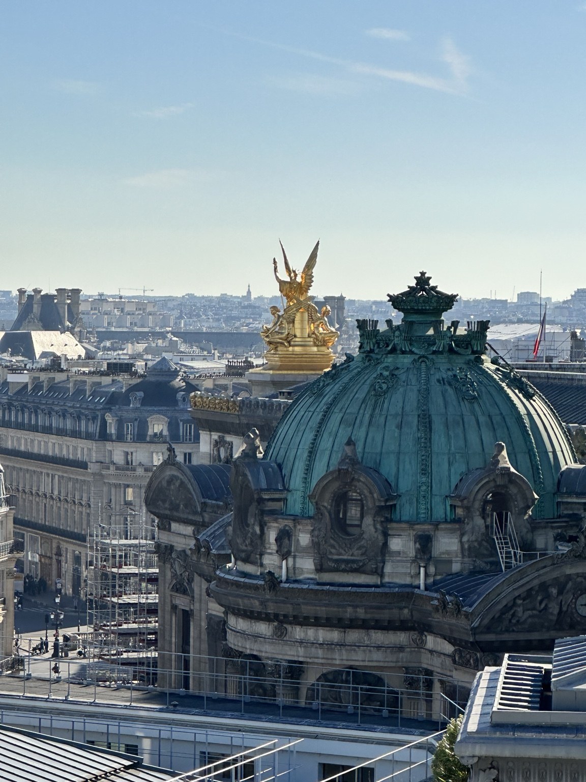 Paris rooftops and an ornate green dome